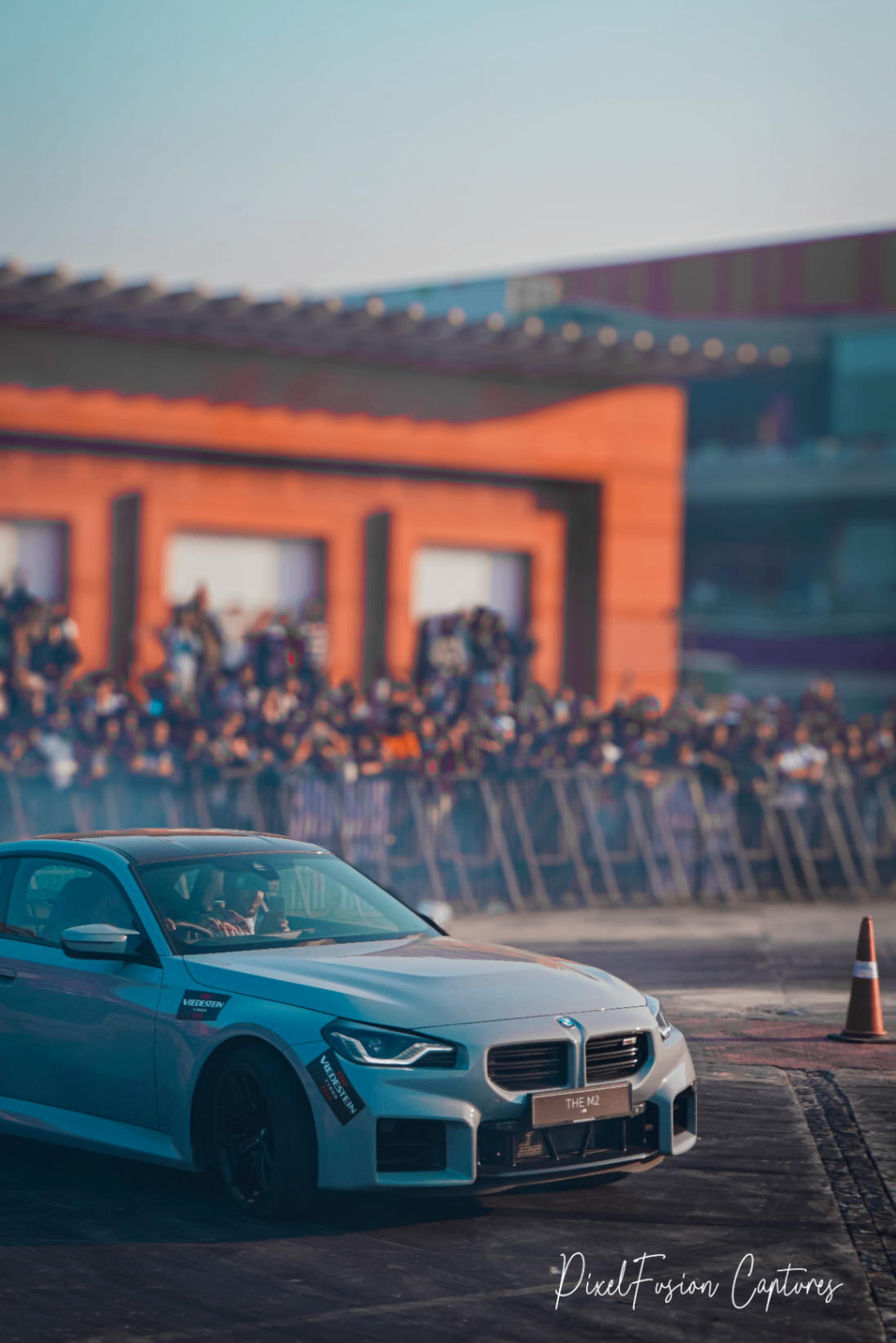 Gray BMW M2 in motion on track