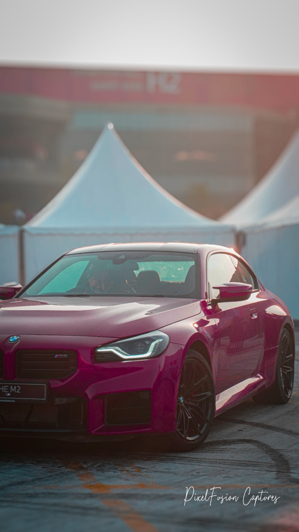 Magenta BMW M2 at golden hour