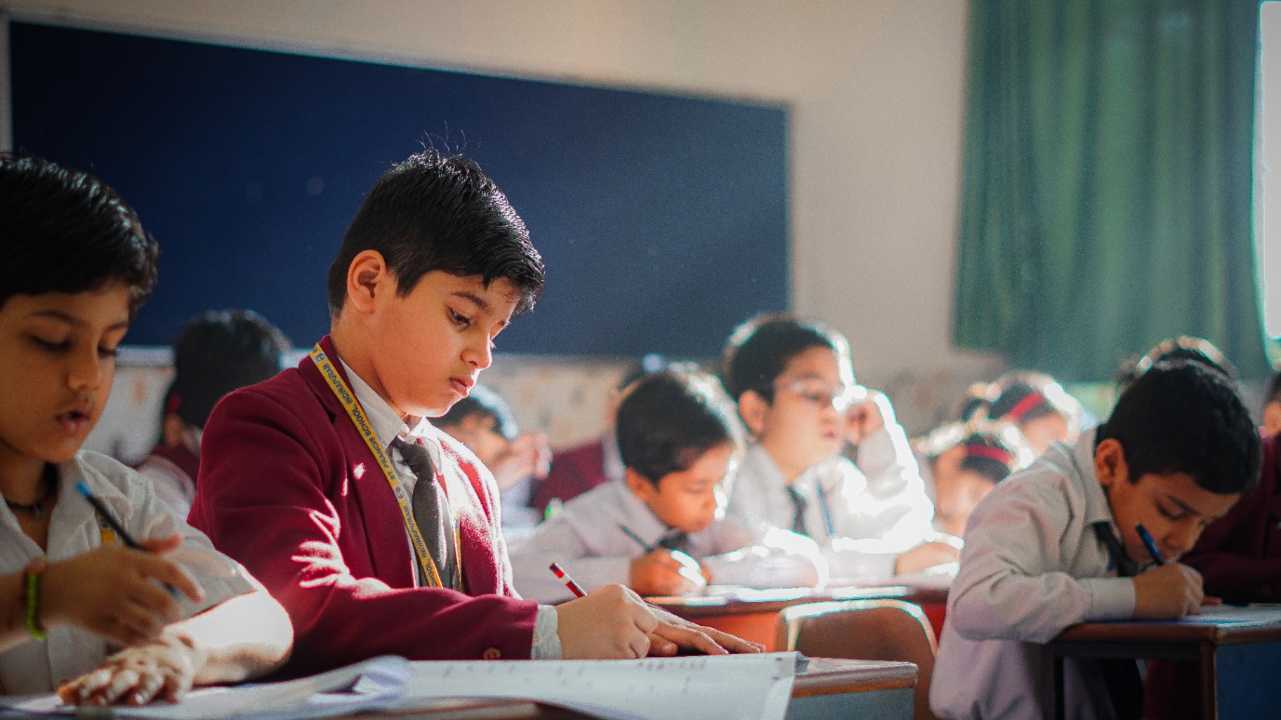Students writing in a classroom